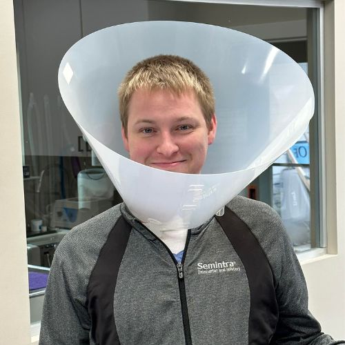 Veterinary staff wearing a cone