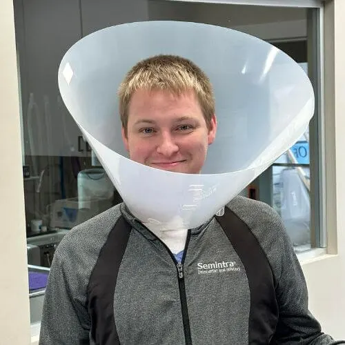 A man wearing a cone-shaped headgear
