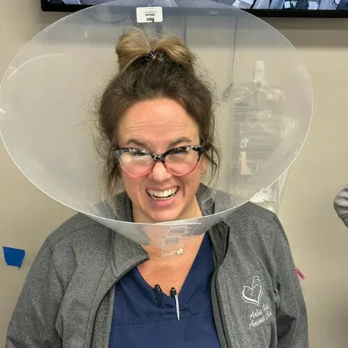 Veterinary staff wearing a cone